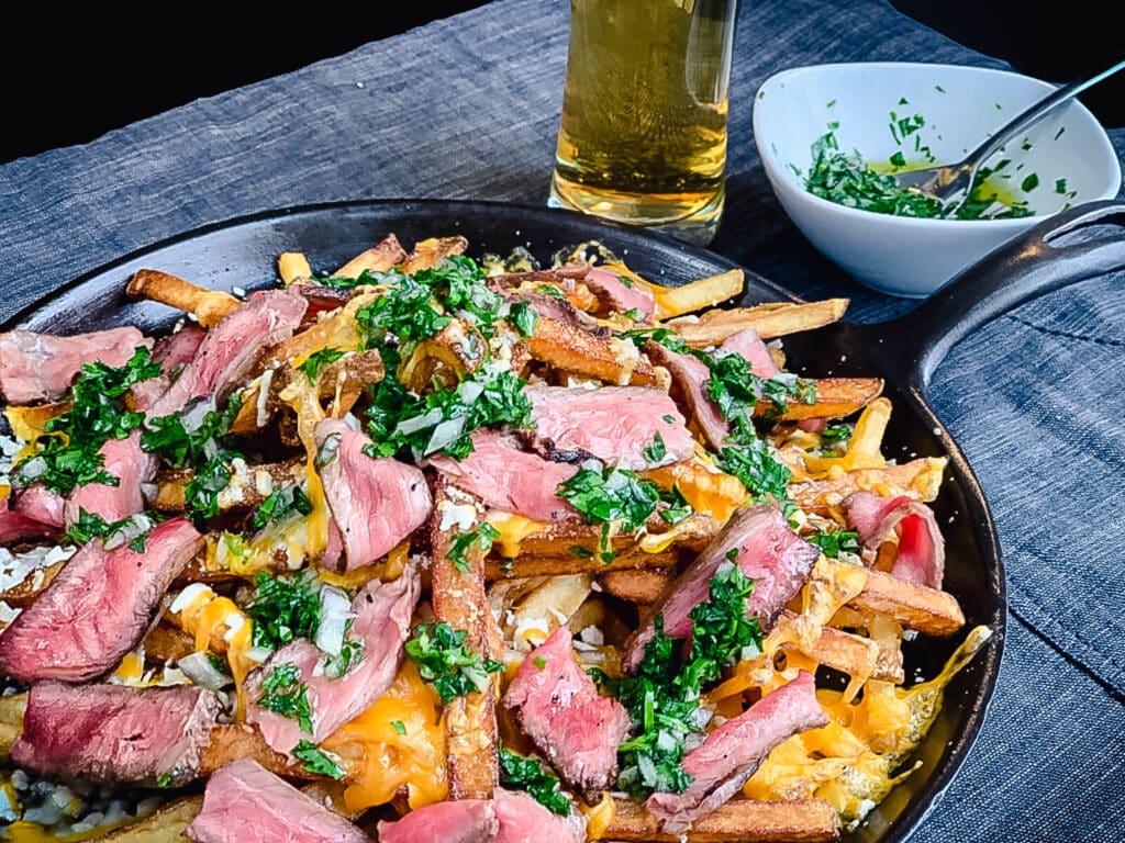 steak loaded fries on a platter