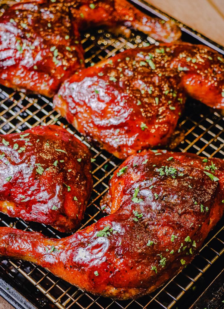 https://www.grillseeker.com/wp-content/uploads/2022/05/bbq-chicken-quarters-on-cooling-rack-with-parsley-744x1024.jpg