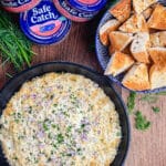 smoked salmon dip in a cast iron pan with bagel bites