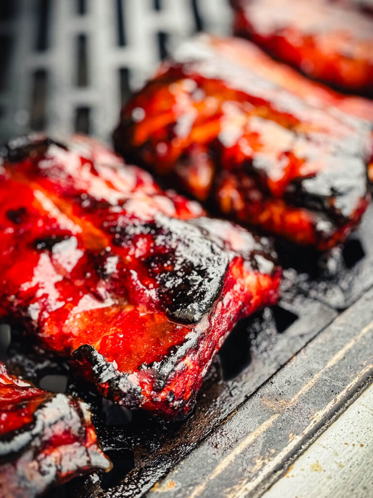 baby back ribs glazed on a grill grate