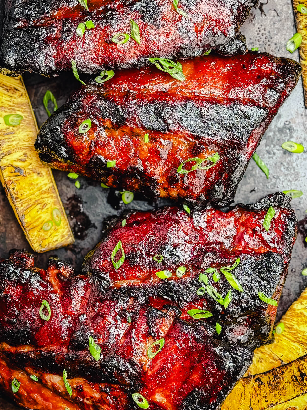huli huli ribs on a platter with grilled pineapple