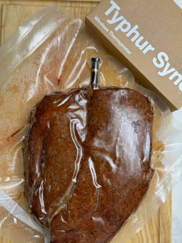 chuck roast with a temperature probe inserted in a vacuum bag for sous vide cooking