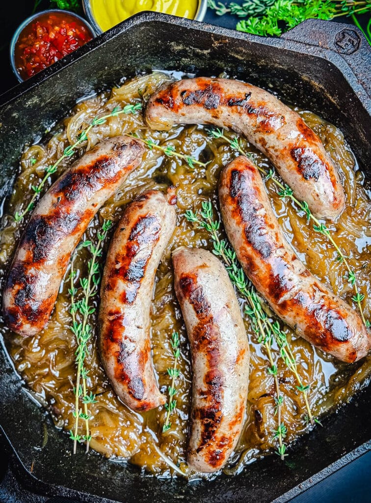 overhead view of beer brats in a cast iron pan