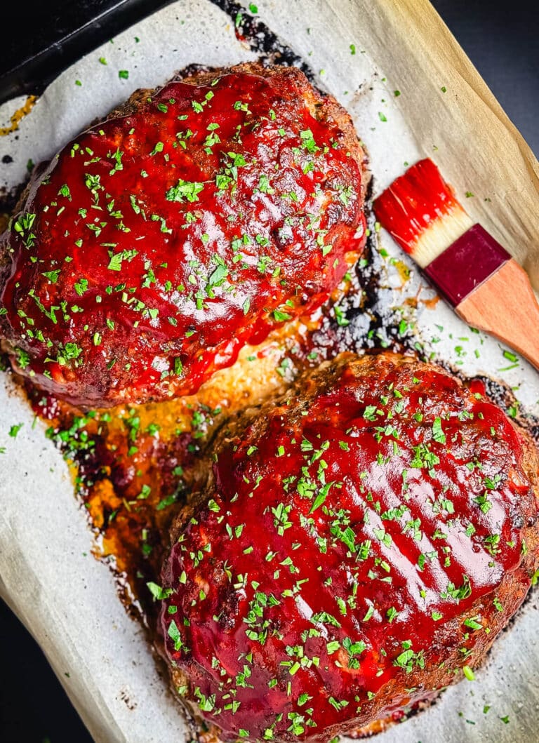 turkey meatloaf on a parchment lined baking sheet