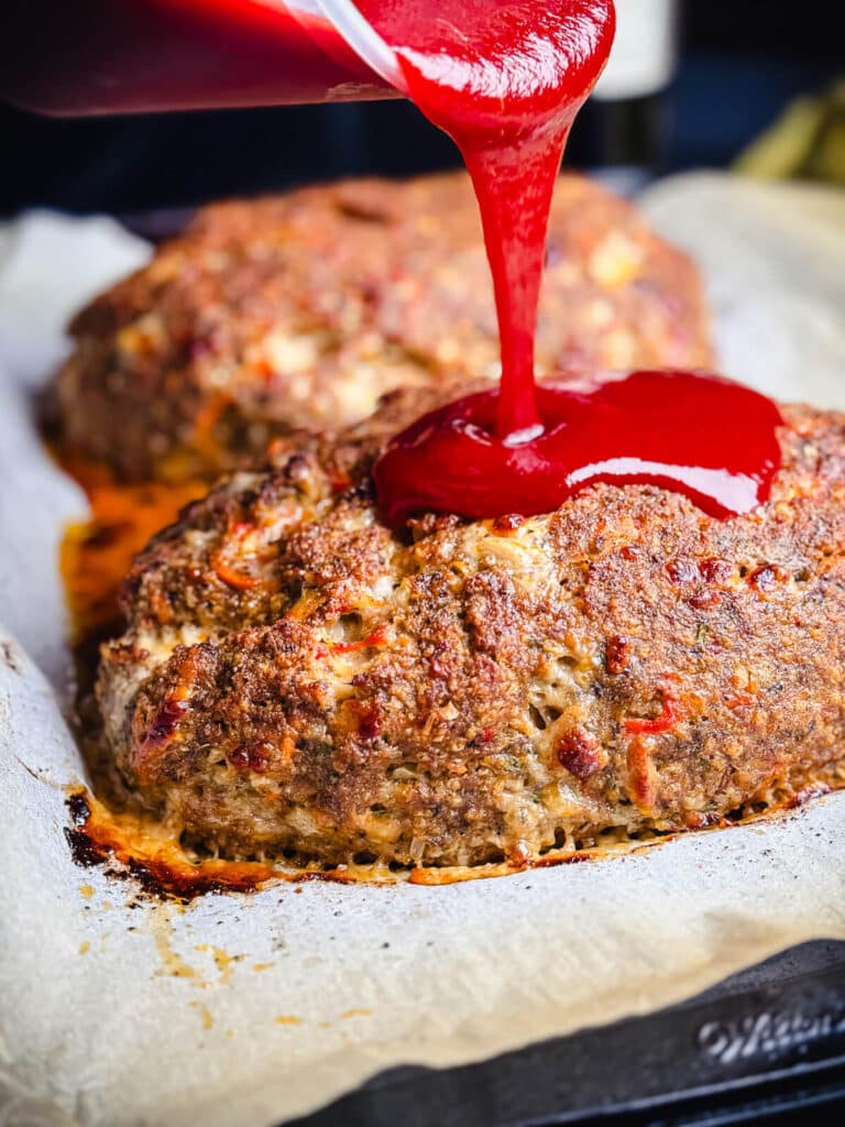 glaze being poured on meatloaf