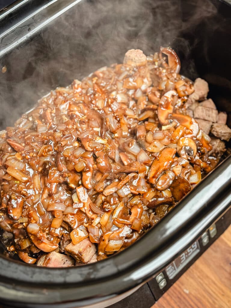 gravy over top of crockpot beef tips in a crockpot