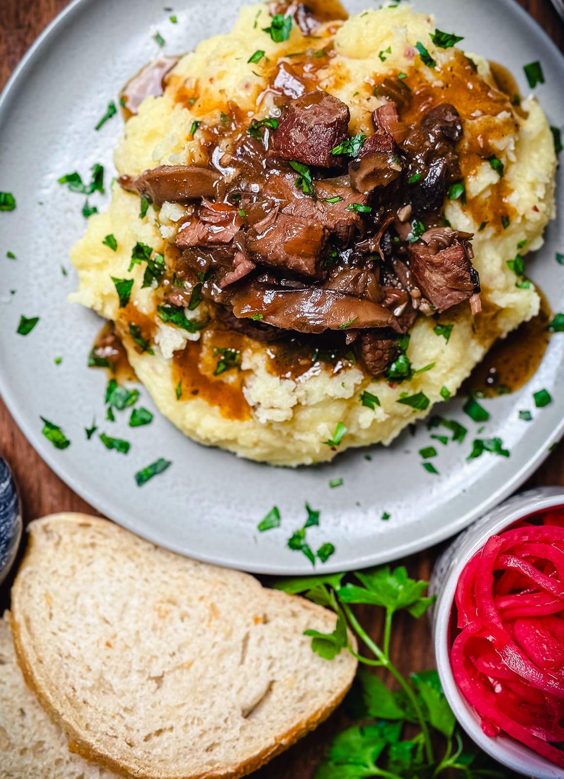 slow cooker beef tips over top of mashed potatoes