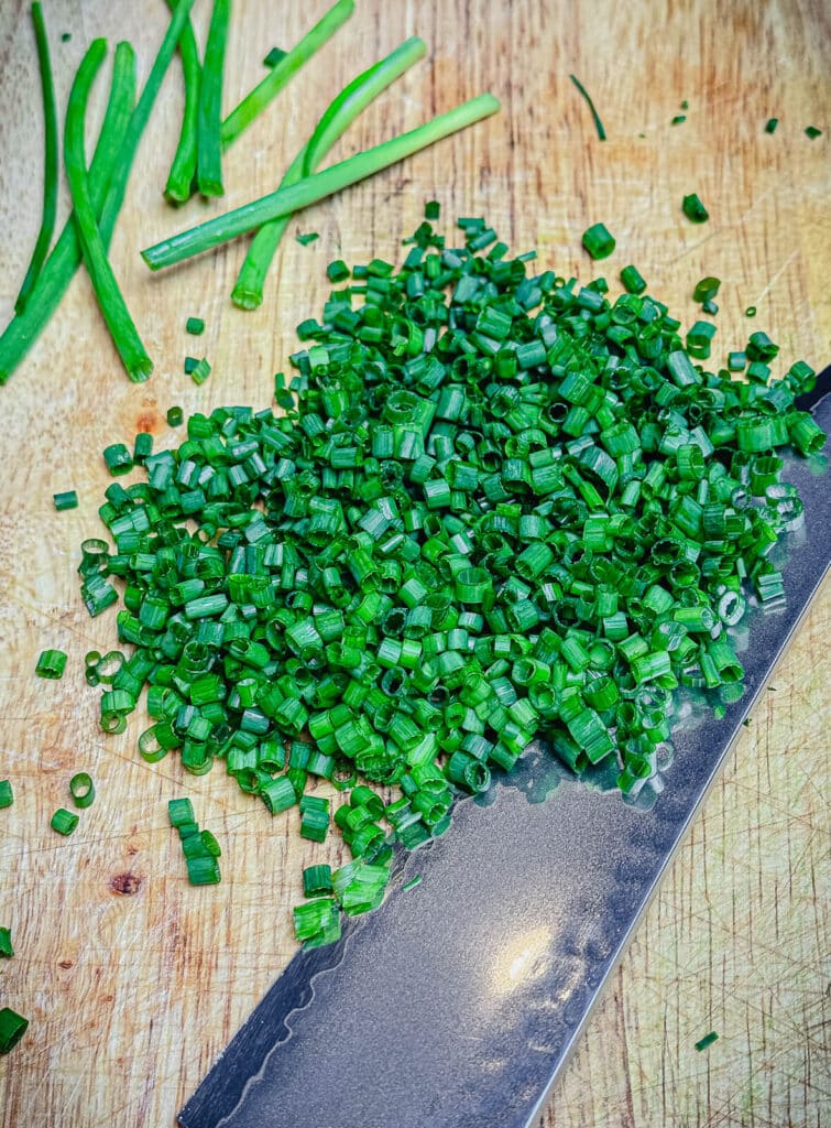 chopped chives on a cutting board