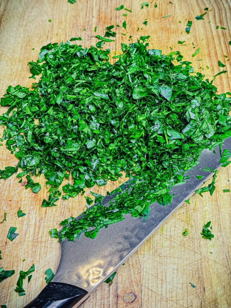 finely chopped parsley on a cutting board