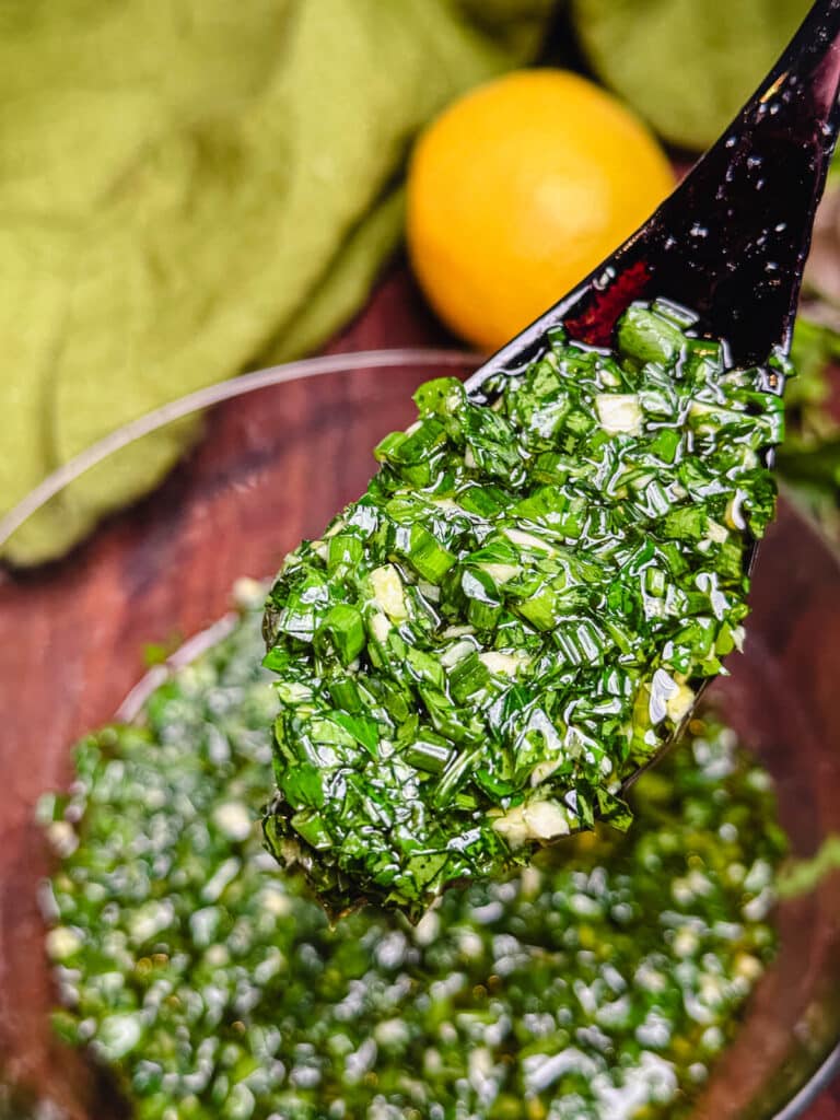 close up of a spoon full of percillade sauce