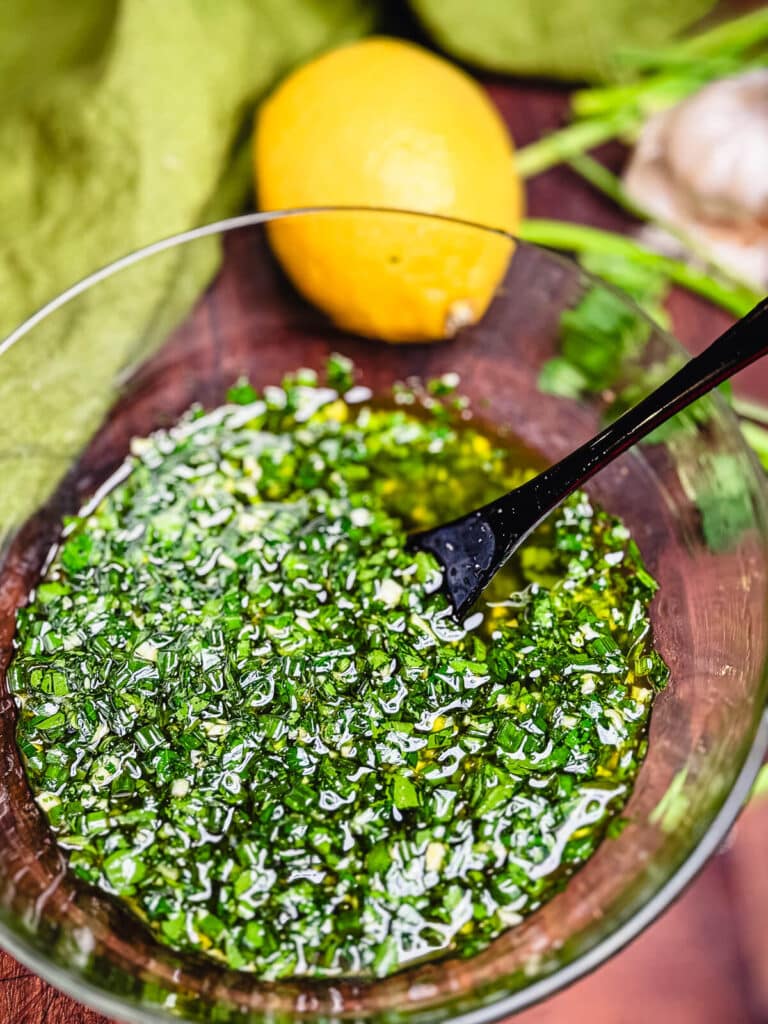 percillade sauce in a glass bowl with a lemon in the background