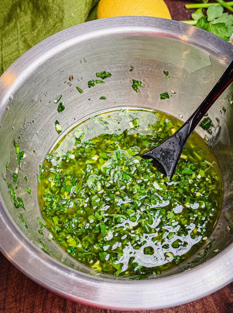 percillade sauce in a mixing bowl with black spoon