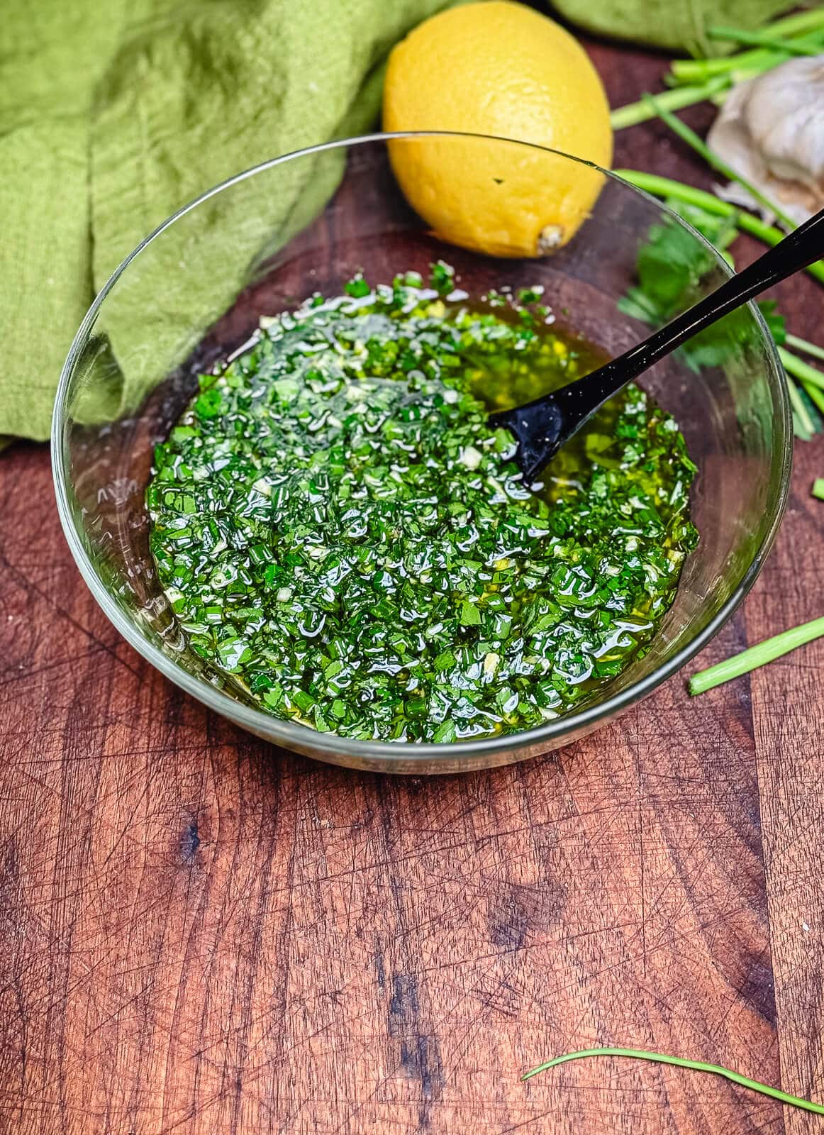 glass bowl filled with percillade sauce and a black spoon