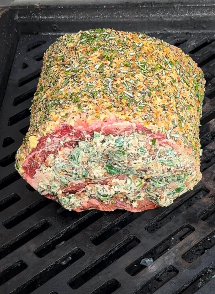 stuffed prime rib on a grill over indirect heat