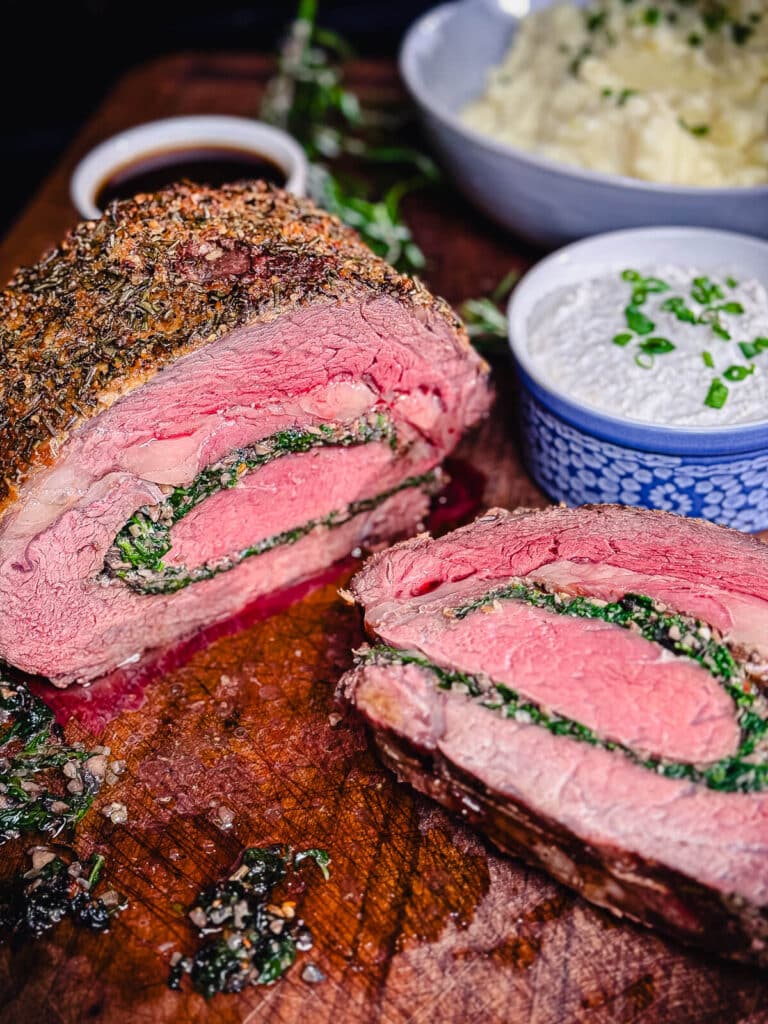 stuffed prime rib sliced on a cutting board