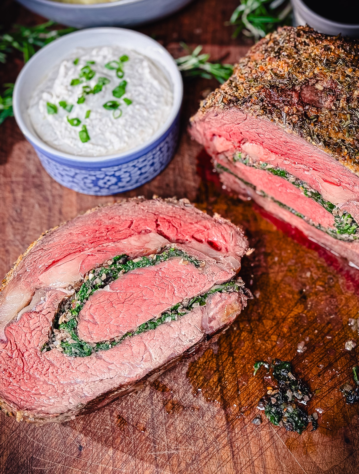 stuffed prime rib sliced on a cutting board