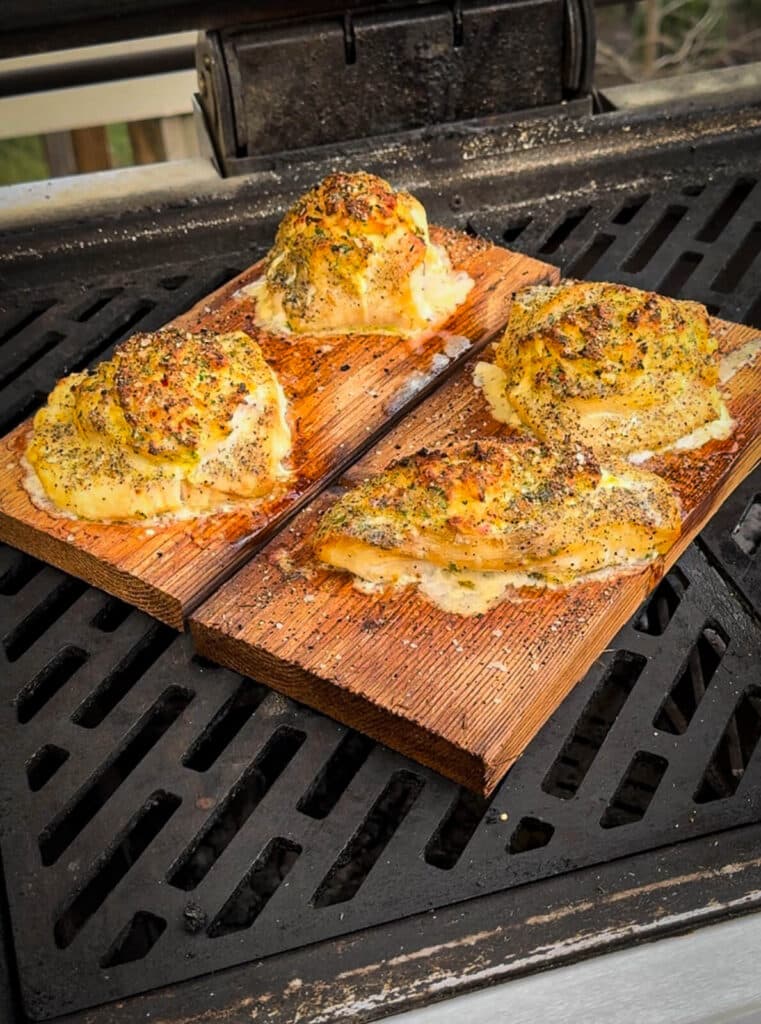 crab stuffed grouper cooked on a cedar plank on the grill