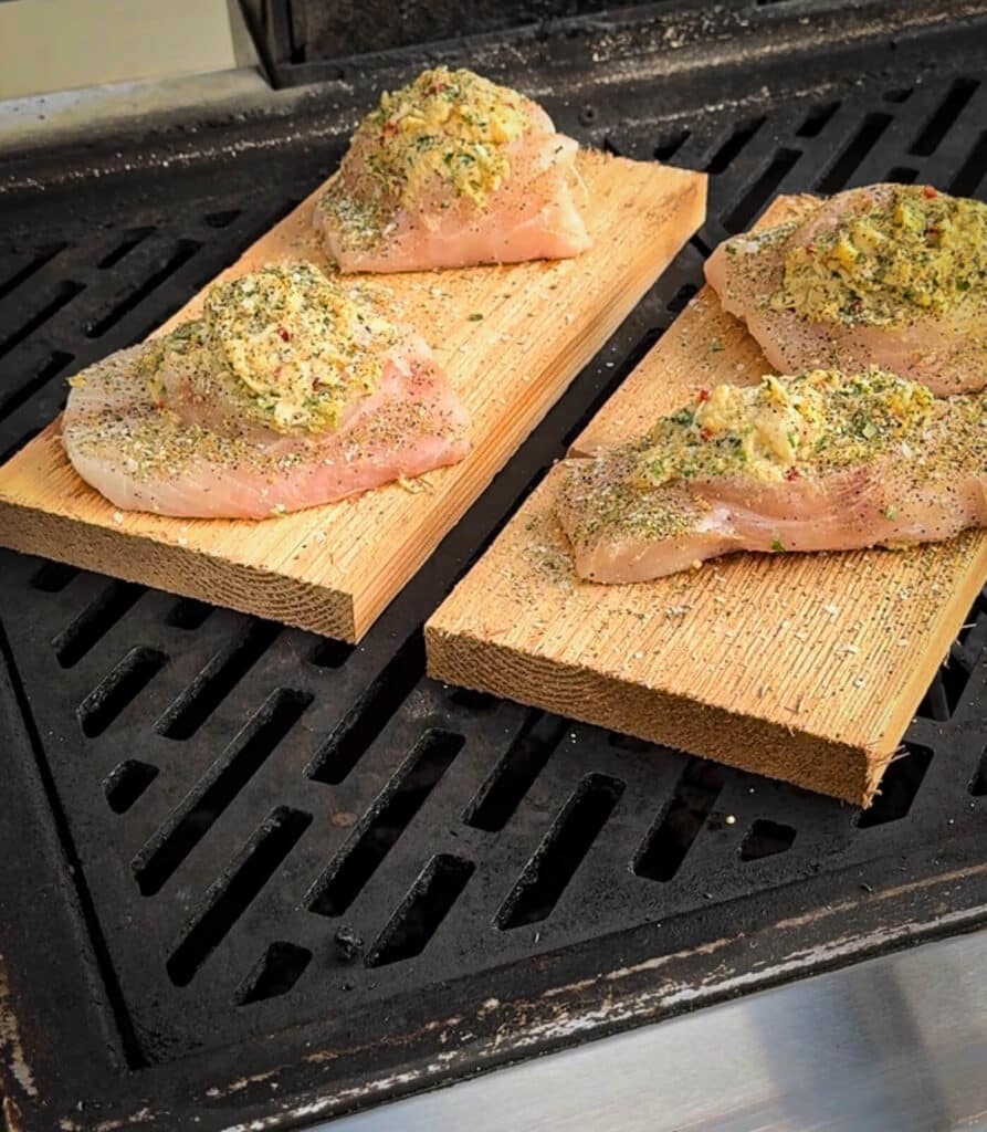 crab stuffed grouper on a grill over indirect heat