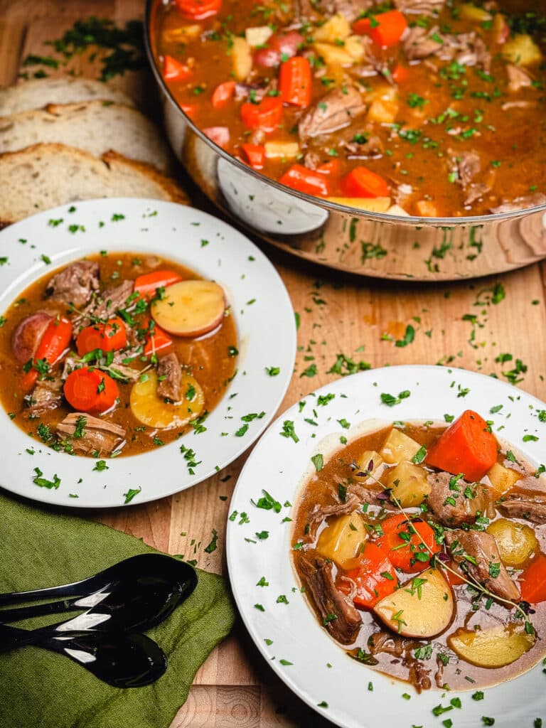 Irish lamb stew in bowls with a pot of stew in the background