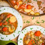 overhead show of irish lamb stew in bowls and in a pot