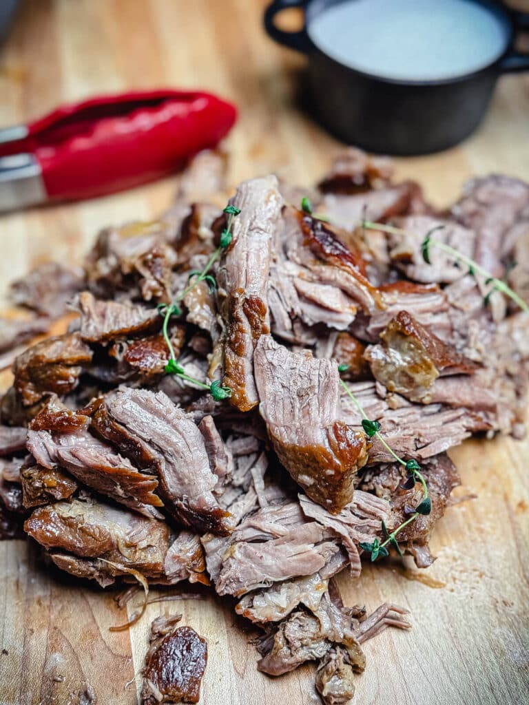 lamb pulled into pieces on a cutting board