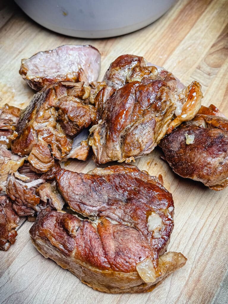 seared lamb on a cutting board