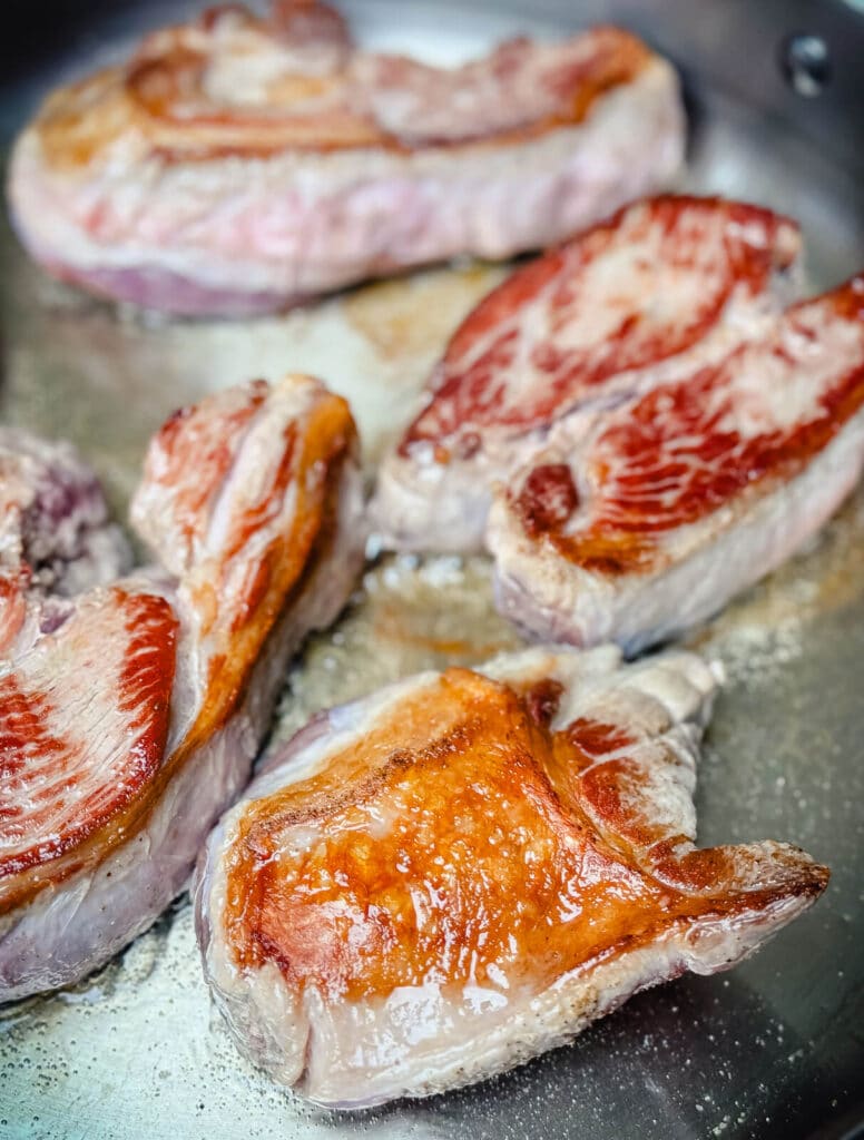 seared lamb slices in a pan