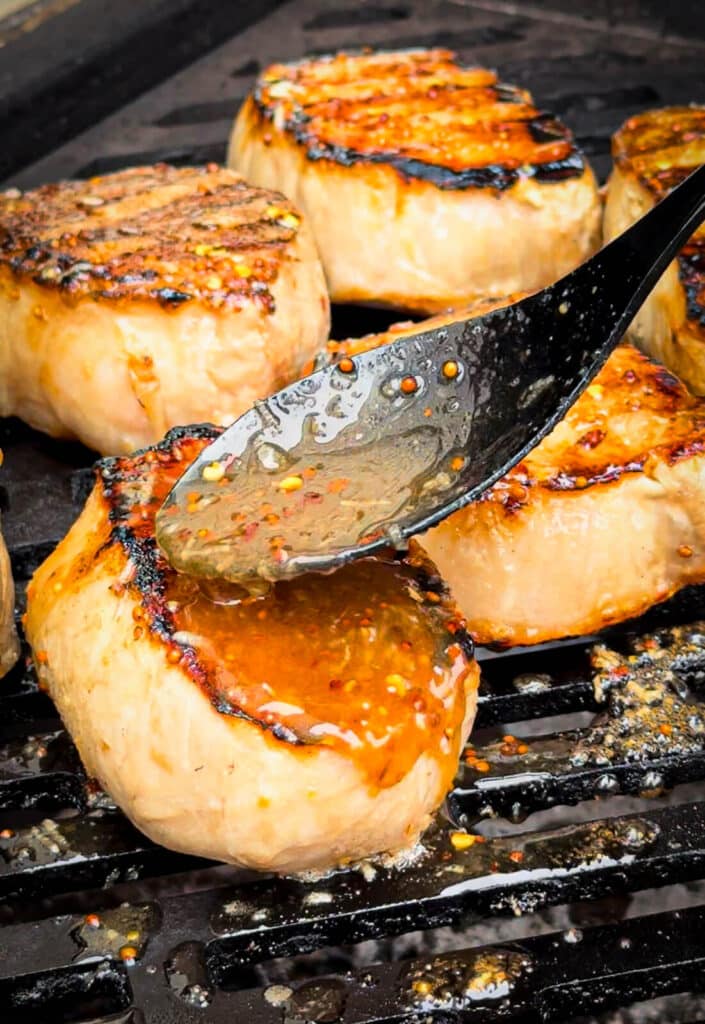 spooning on glaze for mustard glazed pork chops