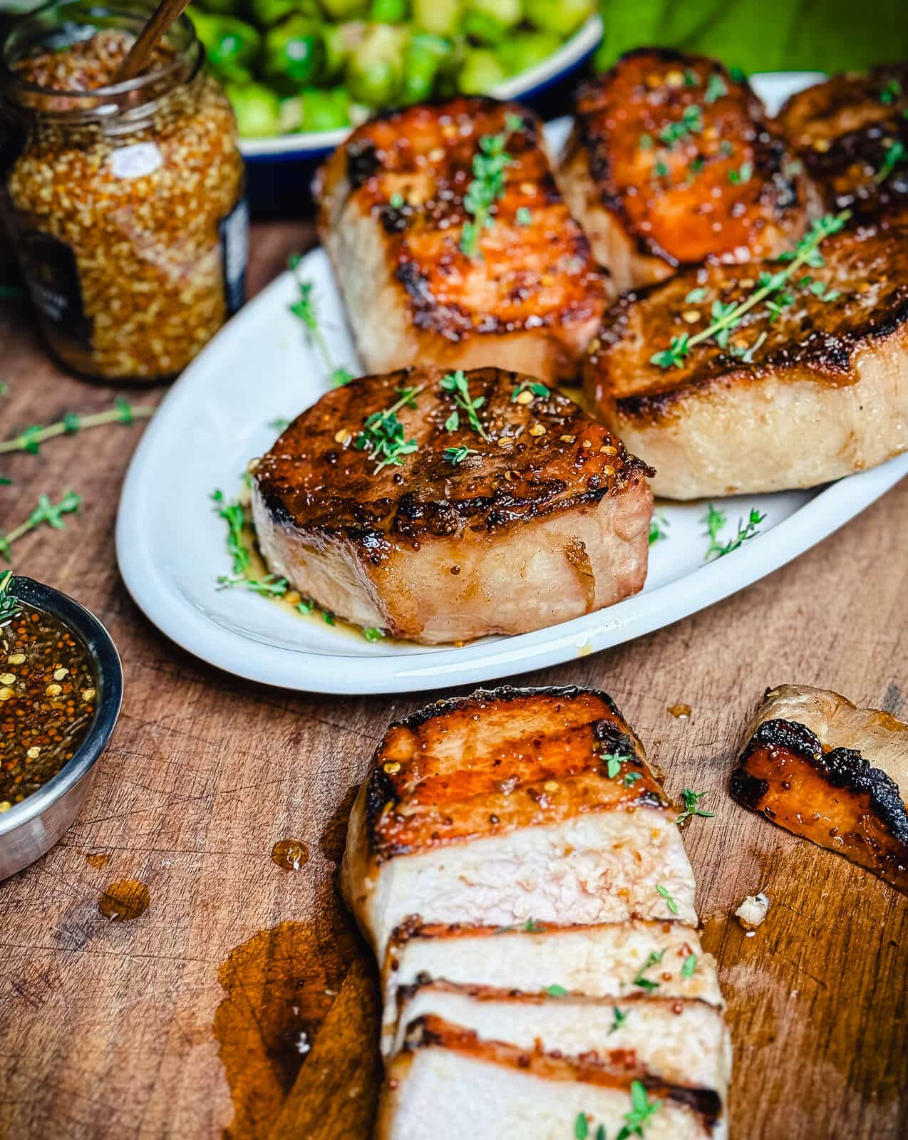 mustard glazed pork chops on a white platter