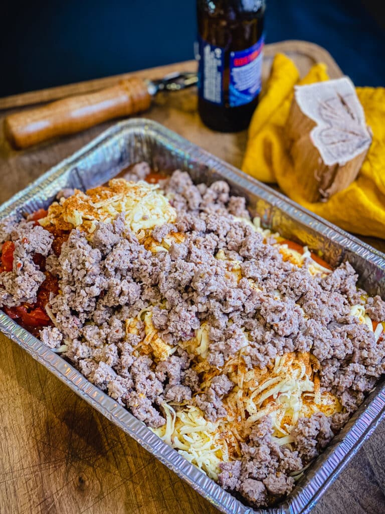 ingredients for smoked queso dip in a large aluminum pan