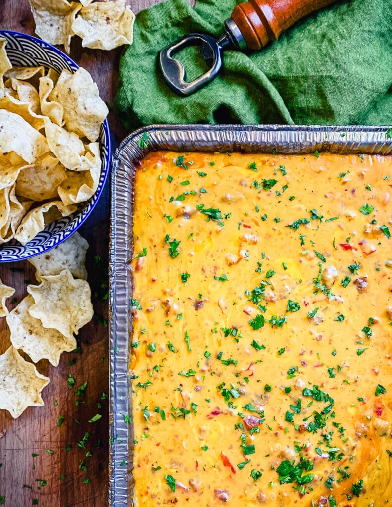 tray full of smoked queso dip garnished with cilantro